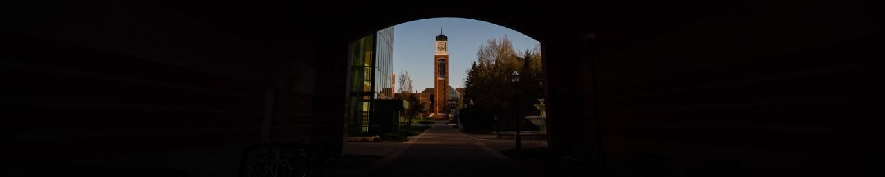 View of the clock tower through the arch of the  Arend & Nancy Lubbers Student Services Center.